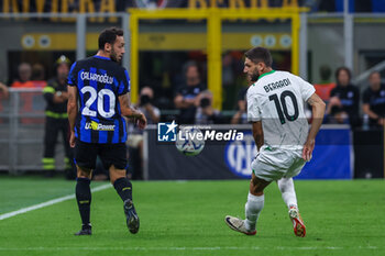 2023-09-27 - Hakan Calhanoglu of FC Internazionale competes for the ball with Domenico Berardi of US Sassuolo during Serie A 2023/24 football match between FC Internazionale and US Sassuolo at Giuseppe Meazza Stadium, Milan, Italy on September 27, 2023 - INTER - FC INTERNAZIONALE VS US SASSUOLO - ITALIAN SERIE A - SOCCER