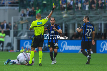 2023-10-07 - Hakan Calhanoglu of FC Internazionale yellow card during Serie A 2023/24 football match between FC Internazionale and Bologna FC at Giuseppe Meazza Stadium, Milan, Italy on October 07, 2023 - INTER - FC INTERNAZIONALE VS BOLOGNA FC - ITALIAN SERIE A - SOCCER