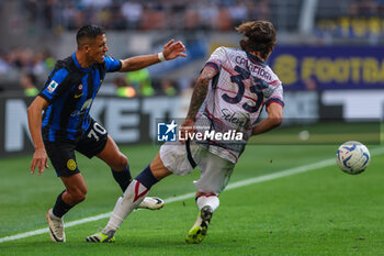 2023-10-07 - Alexis Sanchez of FC Internazionale competes for the ball with Riccardo Calafiori of Bologna FC during Serie A 2023/24 football match between FC Internazionale and Bologna FC at Giuseppe Meazza Stadium, Milan, Italy on October 07, 2023 - INTER - FC INTERNAZIONALE VS BOLOGNA FC - ITALIAN SERIE A - SOCCER