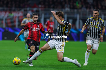 2023-10-22 - Christian Pulisic of AC Milan competes for the ball with Daniele Rugani of Juventus FC during Serie A 2023/24 football match between AC Milan and Juventus FC at San Siro Stadium, Milan, Italy on October 22, 2023 - AC MILAN VS JUVENTUS FC - ITALIAN SERIE A - SOCCER