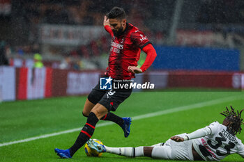 2023-11-04 - Olivier Giroud of AC Milan competes for the ball with Jordan Zemura of Udinese Calcio during Serie A 2023/24 football match between AC Milan and Udinese Calcio at San Siro Stadium, Milan, Italy on November 04, 2023 - AC MILAN VS UDINESE CALCIO - ITALIAN SERIE A - SOCCER