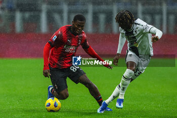 2023-11-04 - Yunus Musah of AC Milan competes for the ball with Jordan Zemura of Udinese Calcio during Serie A 2023/24 football match between AC Milan and Udinese Calcio at San Siro Stadium, Milan, Italy on November 04, 2023 - AC MILAN VS UDINESE CALCIO - ITALIAN SERIE A - SOCCER