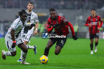 2023-11-04 - Rafael Leao of AC Milan (R) competes for the ball with Festy Ebosele of Udinese Calcio (L) during Serie A 2023/24 football match between AC Milan and Udinese Calcio at San Siro Stadium, Milan, Italy on November 04, 2023 - AC MILAN VS UDINESE CALCIO - ITALIAN SERIE A - SOCCER