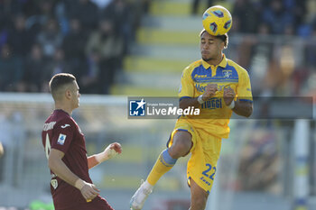 2023-12-10 - Frosinone's Gabonese defender Anthony Oyono challenges for the ball with Torino's Italian defender Alessandro Buongiorno during the Serie A football match between Frosinone Calcio vs Torino at the Benito Stirpe stadium in Frosinone, Italy on December 10, 2023. - FROSINONE CALCIO VS TORINO FC - ITALIAN SERIE A - SOCCER
