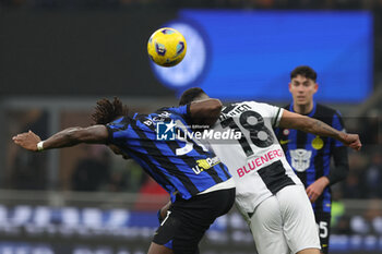 2023-12-09 - Yann Aurel Ludger Bissek of FC Internazionale competes for the ball with Nehuen Perez of Udinese Calcio during Serie A 2023/24 football match between FC Internazionale and Udinese Calcio at Giuseppe Meazza Stadium, Milan, Italy on December 09, 2023 - INTER - FC INTERNAZIONALE VS UDINESE CALCIO - ITALIAN SERIE A - SOCCER
