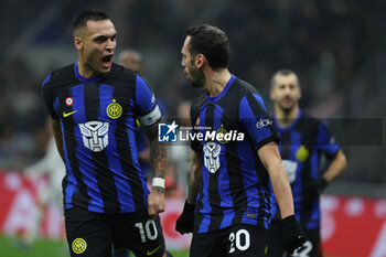 2023-12-09 - Hakan Calhanoglu of FC Internazionale celebrates after scoring a goal with Lautaro Martinez of FC Internazionale during Serie A 2023/24 football match between FC Internazionale and Udinese Calcio at Giuseppe Meazza Stadium, Milan, Italy on December 09, 2023 - INTER - FC INTERNAZIONALE VS UDINESE CALCIO - ITALIAN SERIE A - SOCCER