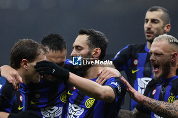 2023-12-09 - Hakan Calhanoglu of FC Internazionale celebrates with his teammates after scoring a goal during Serie A 2023/24 football match between FC Internazionale and Udinese Calcio at Giuseppe Meazza Stadium, Milan, Italy on December 09, 2023 - INTER - FC INTERNAZIONALE VS UDINESE CALCIO - ITALIAN SERIE A - SOCCER