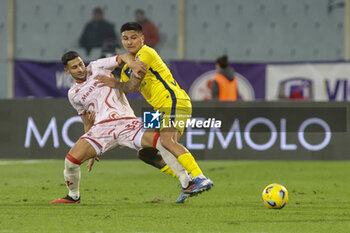 2023-12-17 - Bruno Amione of Hellas Verona FC competes for the ball with Rolando Mandragora of ACF Fiorentina during ACF Fiorentina vs Hellas Verona FC, 16° Serie A Tim 2023-24 game at Artemio Franchi Stadium in Firenze (FI), Italy, on Dicember 17, 2023. - ACF FIORENTINA VS HELLAS VERONA FC - ITALIAN SERIE A - SOCCER
