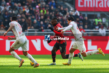 2023-12-17 - Rafael Leao of AC Milan competes for the ball with Andrea Carboni of AC Monza during Serie A 2023/24 football match between AC Milan and AC Monza at San Siro Stadium, Milan, Italy on December 17, 2023 - AC MILAN VS AC MONZA - ITALIAN SERIE A - SOCCER