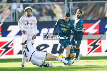 2023-12-23 - Juventus' ItalianD\ Andrea Cambiaso challenges for the ball with Frosinone's Argentinian forward Matias Soule during the Serie A football match between Frosinone Calcio vs Juventus FC at the Benito Stirpe stadium in Frosinone, Italy on December 23, 2023. - FROSINONE CALCIO VS JUVENTUS FC - ITALIAN SERIE A - SOCCER