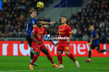 2023-12-23 - Nicolo Barella of FC Internazionale competes for the ball with Lamerk Banda of US Lecce and Roberto Piccoli of US Lecce during Serie A 2023/24 football match between FC Internazionale and US Lecce at Giuseppe Meazza Stadium, Milan, Italy on December 23, 2023 - INTER - FC INTERNAZIONALE VS US LECCE - ITALIAN SERIE A - SOCCER