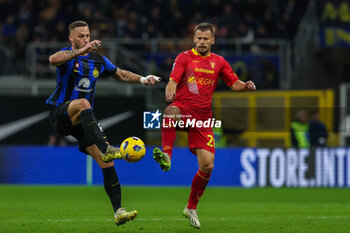 2023-12-23 - Marko Arnautovic of FC Internazionale competes for the ball with Ylber Ramadani of US Lecce during Serie A 2023/24 football match between FC Internazionale and US Lecce at Giuseppe Meazza Stadium, Milan, Italy on December 23, 2023 - INTER - FC INTERNAZIONALE VS US LECCE - ITALIAN SERIE A - SOCCER