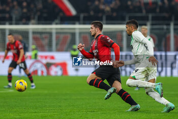 2023-12-30 - Luka Jovic of AC Milan seen in action with Ruan Tressoldi of US Sassuolo during Serie A 2023/24 football match between AC Milan and US Sassuolo at San Siro Stadium, Milan, Italy on December 30, 2023 - AC MILAN VS US SASSUOLO - ITALIAN SERIE A - SOCCER