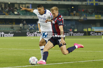 2023-09-18 - Victor Kristiansen of Bologna FC competes for the ball with Marco Davide Faraoni of Hellas Verona FC during Hellas Verona FC vs Bologna FC, 4° Serie A Tim 2023-24 game at Marcantonio Bentegodi Stadium in Verona, Italy, on September 18, 2023. - HELLAS VERONA FC VS BOLOGNA FC - ITALIAN SERIE A - SOCCER