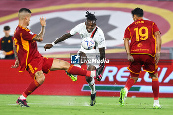 2023-09-01 - Rafael Leao of Milan (C) kicks the ball under pressure from Gianluca Mancini (L) and Zeki Celik (R) during the Italian championship Serie A football match between AS Roma and AC Milan on September 1, 2023 at Stadio Olimpico in Rome, Italy - FOOTBALL - ITALIAN CHAMP - AS ROMA V AC MILAN - ITALIAN SERIE A - SOCCER