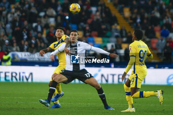 2023-12-03 - Bruno Amione of Hellas Verona FC competes for the ball with Lorenzo Lucca of Udinese FC  during Udinese Calcio vs Hellas Verona FC, 14° Serie A Tim 2023-24 game at Bluenergy Stadium - Stadio Friuli in Udine (UD), Italy, on Dicember 03, 2023. - UDINESE CALCIO VS HELLAS VERONA FC - ITALIAN SERIE A - SOCCER