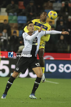 2023-12-03 - Jackosn Tchatchousa of Hellas Verona FC battle for the ball with Lorenzo Lucca of Udinese FC  during Udinese Calcio vs Hellas Verona FC, 14° Serie A Tim 2023-24 game at Bluenergy Stadium - Stadio Friuli in Udine (UD), Italy, on Dicember 03, 2023. - UDINESE CALCIO VS HELLAS VERONA FC - ITALIAN SERIE A - SOCCER