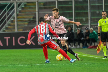 2023-12-26 - Kristoffer Lund (Palermo F.C.) in action against Paolo Ghiglione (U.S. Cremonese) during the Italian Serie BKT match between Palermo F.C. vs. U.S. Cremonese at the Renzo Barbera Stadium in Palermo, Italy - PALERMO FC VS US CREMONESE - ITALIAN SERIE B - SOCCER
