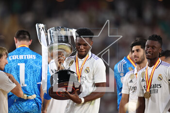 2023-05-06 - Aurelien Tchouameni of Real Madrid celebrates with the Champions trophy after the Spanish Cup, Copa del Rey, Final football match between Real Madrid CF and CA Osasuna on May 6, 2023 at Estadio de La Cartuja in Sevilla, Spain - FOOTBALL - SPANISH CUP - FINAL - REAL MADRID V OSASUNA - SPANISH CUP - SOCCER