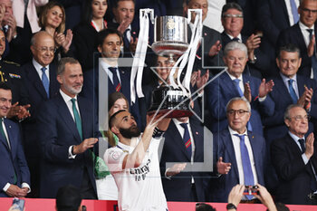 2023-05-06 - Karim Benzema of Real Madrid receives the champions trophy from Felipe VI and Infanta Sofia after the Spanish Cup, Copa del Rey, Final football match between Real Madrid CF and CA Osasuna on May 6, 2023 at Estadio de La Cartuja in Sevilla, Spain - FOOTBALL - SPANISH CUP - FINAL - REAL MADRID V OSASUNA - SPANISH CUP - SOCCER
