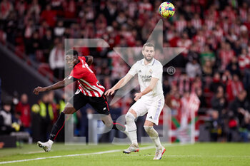 2023-01-22 - Inaki Williams of Athletic Club competes for the ball with Nacho Fernandez of Real Madrid during the Spanish championship La Liga football match between Athletic Club and Real Madrid CF on January 22, 2023 at San Mames stadium in Bilbao, Spain - FOOTBALL - SPANISH CHAMP - ATHLETIC CLUB V REAL MADRID - SPANISH LA LIGA - SOCCER