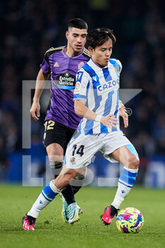 2023-02-05 - Takefusa Kubo of Real Sociedad competes for the ball with Lucas Olaza of Real Valladolid CF during the Spanish championship La Liga football match between Real Sociedad and Real Valladolid CF on February 5, 2023 at Reale Arena in San Sebastian, Spain - FOOTBALL - SPANISH CHAMP - REAL SOCIEDAD V REAL VALLADOLID - SPANISH LA LIGA - SOCCER