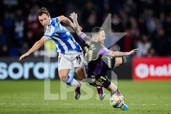 2023-02-05 - Jon Ander Olasagasti of Real Sociedad competes for the ball with Ivan Sanchez of Real Valladolid CF during the Spanish championship La Liga football match between Real Sociedad and Real Valladolid CF on February 5, 2023 at Reale Arena in San Sebastian, Spain - FOOTBALL - SPANISH CHAMP - REAL SOCIEDAD V REAL VALLADOLID - SPANISH LA LIGA - SOCCER
