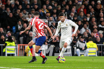 2023-02-25 - Mario Hermoso of Atletico de Madrid and Marco Asensio of Real Madrid during the Spanish championship La Liga football match between Real Madrid and Atletico de Madrid on February 25, 2023 at Santiago Bernabeu stadium in Madrid, Spain - FOOTBALL - SPANISH CHAMP - REAL MADRID V ATLETICO MADRID - SPANISH LA LIGA - SOCCER