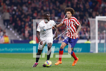 2023-03-04 - Pape Gueye of Sevilla FC and Axel Witsel of Atletico de Madrid during the Spanish championship La Liga football match between Atletico de Madrid and Sevilla FC on March 4, 2023 at Civitas Metripolitano stadium in Madrid, Spain - FOOTBALL - SPANISH CHAMP - ATLETICO MADRID V SEVILLA FC - SPANISH LA LIGA - SOCCER