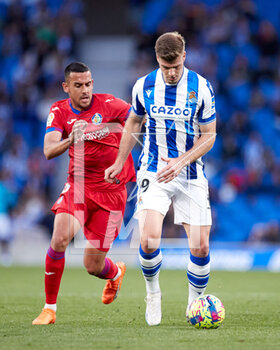 2023-04-08 - Angel Algobia of Getafe CF competes for the ball with Alexander Sorloth of Real Sociedad during the Spanish championship La Liga football match between Real Sociedad and Getafe CF on April 8, 2023 at Reale Arena in San Sebastian, Spain - FOOTBALL - SPANISH CHAMP - REAL SOCIEDAD V GETAFE - SPANISH LA LIGA - SOCCER