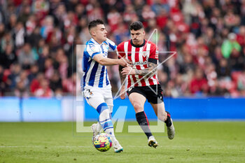 2023-04-15 - Ander Barrenetxea of Real Sociedad competes for the ball with Ander Capa of Athletic Club during the Spanish championship La Liga football match between Athletic Club and Real Sociedad on April 15, 2023 at San Mames stadium in Bilbao, Spain - FOOTBALL - SPANISH CHAMP - ATHLETIC CLUB V REAL SOCIEDAD - SPANISH LA LIGA - SOCCER