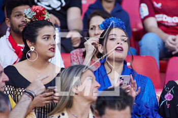 2023-04-23 - A Sevilla FC fans is seen with the typical flamenco dress for April Fair in Sevilla during the Spanish championship La Liga football match between Sevilla FC and Villarreal on April 23, 2023 at Ramon Sanchez Pizjuan stadium in Sevilla, Spain - FOOTBALL - SPANISH CHAMP - SEVILLA FC V VILLARREAL - SPANISH LA LIGA - SOCCER