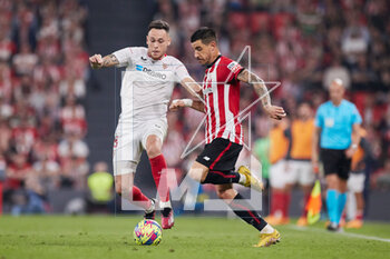 2023-04-27 - Yuri Berchiche of Athletic Club competes for the ball with Lucas Ocampos of Sevilla FC during the Spanish championship La Liga football match between Athletic Club and Sevilla FC on April 27, 2023 at San Mames stadium in Bilbao, Spain - FOOTBALL - SPANISH CHAMP - ATHLETIC CLUB V SEVILLA FC - SPANISH LA LIGA - SOCCER