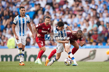 2023-06-04 - Carlos Fernandez of Real Sociedad competes for the ball with Oliver Torres of Sevilla FC during the Spanish championship La Liga football match between Real Sociedad and Sevilla FC on June 4, 2023 at Reale Arena in San Sebastian, Spain - FOOTBALL - SPANISH CHAMP - REAL SOCIEDAD V SEVILLA FC - SPANISH LA LIGA - SOCCER