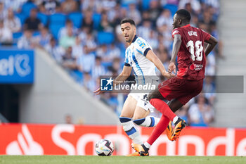 2023-06-04 - Mikel Merino of Real Sociedad competes for the ball with Pape Alassane Gueye of Sevilla FC during the Spanish championship La Liga football match between Real Sociedad and Sevilla FC on June 4, 2023 at Reale Arena in San Sebastian, Spain - FOOTBALL - SPANISH CHAMP - REAL SOCIEDAD V SEVILLA FC - SPANISH LA LIGA - SOCCER