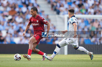 2023-06-04 - Loic Bade of Sevilla FC competes for the ball with Ander Barrenetxea of Real Sociedad during the Spanish championship La Liga football match between Real Sociedad and Sevilla FC on June 4, 2023 at Reale Arena in San Sebastian, Spain - FOOTBALL - SPANISH CHAMP - REAL SOCIEDAD V SEVILLA FC - SPANISH LA LIGA - SOCCER