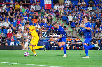 2023-08-13 - Raphinha (Barcelona) and Fabrizio German Angileri (Getafe) in action during the LaLiga EA Sports football match between Getafe and Barcelona played at Coliseum Alfonso Perez Stadium on August 13, 2023 in Getafe, Spain - GETAFE VS BARCELONA - SPANISH LA LIGA - SOCCER