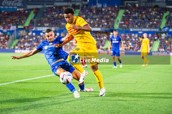 2023-08-13 - Alejandro Balde (Barcelona) and Stefan Mitrovic (Getafe) in action during the LaLiga EA Sports football match between Getafe and Barcelona played at Coliseum Alfonso Perez Stadium on August 13, 2023 in Getafe, Spain - GETAFE VS BARCELONA - SPANISH LA LIGA - SOCCER