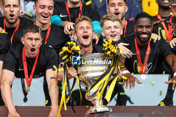 2023-04-30 - 04.06.2023, Bern, Wankdorf, CUP Final: BSC Young Boys - FC Lugano, #28 Fabian Lustenberger (Young Boys) with Swiss Cup trophy. #16 Christian Fassnacht (Young Boys, left) and #21 Ulisses Garcia (Young Boys, right) - CUP FINAL: BSC YOUNG BOYS - FC LUGANO - SWISS CUP - SOCCER