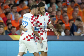 2023-06-14 - Andrej Kramaric of Croatia celebrates his goal with Josip Juranovic (left) during the UEFA Nations League, Semi-finals football match between Netherlands and Croatia on June 14, 2023 at Stadion Feijenoord 'De Kuip' in Rotterdam, Netherlands - FOOTBALL - UEFA NATIONS LEAGUE 2023 - 1/2 - NETHERLANDS V CROATIA - UEFA NATIONS LEAGUE - SOCCER