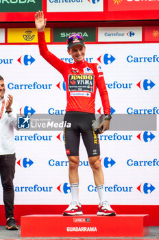 2023-09-16 - Sepp Kuss (Jumbo-Visma), red jersey and winner of the Vuelta Espana 2023, celebrates on the podium at the end of the stage 20 of the Spanish bicycle race La Vuelta on September 16, 2023 in Guadarrama, Spain - LA VUELTA - STAGE 20 - MANZANARES EL REAL - GUADARRAMA - SPANISH LA VUELTA - CYCLING