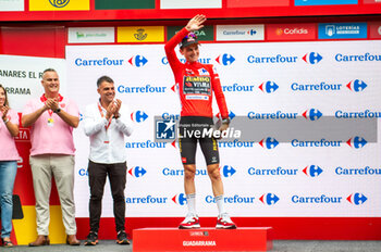 2023-09-16 - Sepp Kuss (Jumbo-Visma), red jersey and winner of the Vuelta Espana 2023, celebrates on the podium at the end of the stage 20 of the Spanish bicycle race La Vuelta on September 16, 2023 in Guadarrama, Spain - LA VUELTA - STAGE 20 - MANZANARES EL REAL - GUADARRAMA - SPANISH LA VUELTA - CYCLING