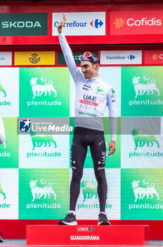 2023-09-16 - Juan Ayuso (UAE Team Emirates), youth jersey of the Vuelta Espana 2023, celebrates on the podium at the end of the stage 20 of the Spanish bicycle race La Vuelta on September 16, 2023 in Guadarrama, Spain - LA VUELTA - STAGE 20 - MANZANARES EL REAL - GUADARRAMA - SPANISH LA VUELTA - CYCLING