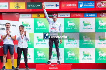 2023-09-16 - Juan Ayuso (UAE Team Emirates), youth jersey of the Vuelta Espana 2023, celebrates on the podium at the end of the stage 20 of the Spanish bicycle race La Vuelta on September 16, 2023 in Guadarrama, Spain - LA VUELTA - STAGE 20 - MANZANARES EL REAL - GUADARRAMA - SPANISH LA VUELTA - CYCLING