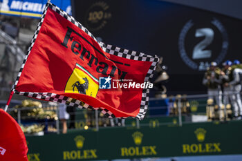 2023-06-11 - Ferrari flag during the podium of the 24 Hours of Le Mans 2023 on the Circuit des 24 Heures du Mans on June 11, 2023 in Le Mans, France - AUTO - LE MANS 2023 - PODIUM - ENDURANCE - MOTORS