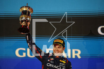 2023-03-05 - PEREZ Sergio (mex), Red Bull Racing RB19, portrait celebrates his podium with the trophy during the Formula 1 Gulf Air Bahrain Grand Prix 2023, 1st round of the 2023 FIA Formula One World Championship from March 2 to 5, 2023 on the Bahrain International Circuit, in Sakhir, Bahrain - F1 - BAHRAIN GRAND PRIX 2023 - RACE - FORMULA 1 - MOTORS