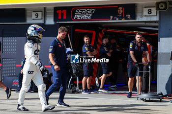 2023-07-22 - RICCIARDO Daniel (aus), Scuderia AlphaTauri AT04, passing in front of the garage of PEREZ Sergio (mex), Red Bull Racing, in the pitlane, during the 2023 Formula 1 Qatar Airways Hungarian Grand Prix, 11th round of the 2023 Formula One World Championship from July 21 to 23, 2023 on the Hungaroring, in Mogyorod, Hungary - F1 - HUNGARIAN GRAND PRIX 2023 - FORMULA 1 - MOTORS