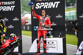 2023-06-10 - Francesco Bagnaia IT Ducati Lenovo Team Ducati celebrates on the podium after winning the Gran Premio d'Italia Oakley - TISSOT SPRINT MOTOGP GRAND PRIX OF ITALY - MOTOGP - MOTORS