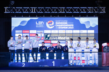 05/12/2023 - Team of Great Britain, Team of Italy and Team of Greece during the prize giving ceremony for Men´s 4x50m Freestyle at the LEN Short Course European Championships 2023 on December 5, 2023 in Otopeni, Romania - SWIMMING - LEN SHORT COURSE EUROPEAN CHAMPIONSHIPS 2023 - NUOTO - NUOTO