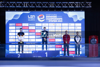 2023-12-06 - Tomac Mewen of France, Braunschweig Ole of Germany, Mora Lorenzo of Italy and Bollin Thierry of Switzerland during the podium ceremony of Men’s 50m Backstroke at the LEN Short Course European Championships 2023 on December 6, 2023 in Otopeni, Romania - SWIMMING - LEN SHORT COURSE EUROPEAN CHAMPIONSHIPS 2023 - DAY 2 - SWIMMING - SWIMMING